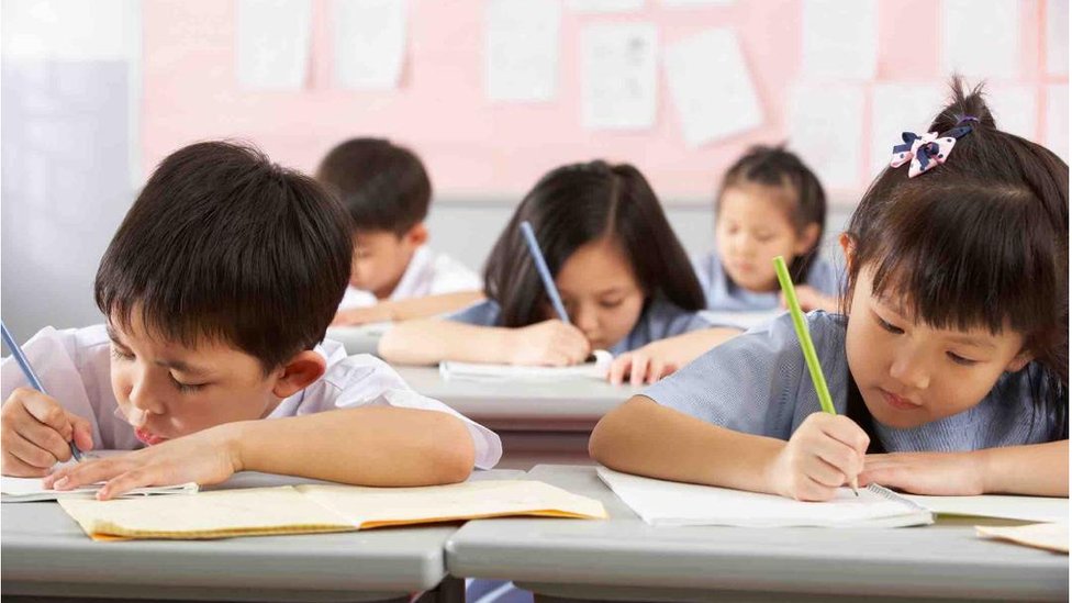 Children writing in school in China